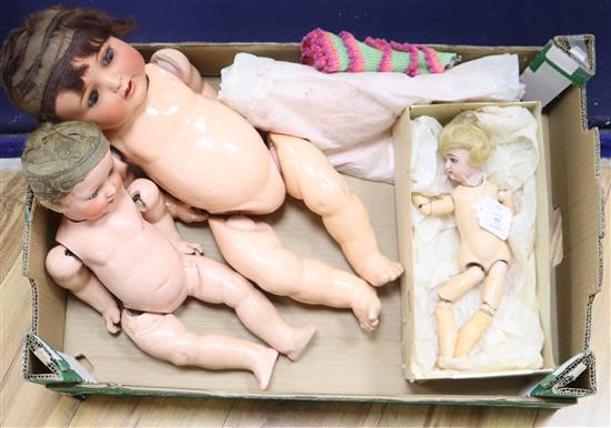 A smart bisque-headed doll, two others and a collection of dolls clothes